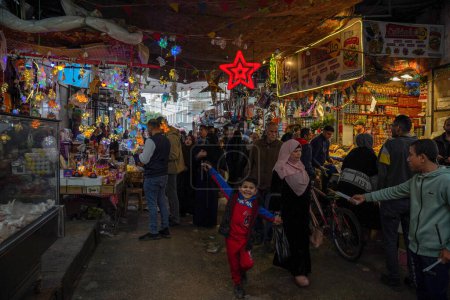 Photo for (INT) Palestinians shop and prepare to receive the month of Ramadan. March 21, 2023, Gaza, Palestine: Palestinians go to the markets to buy supplies for the month of Ramadan, such as supplies for decorating homes and buying food. - Royalty Free Image