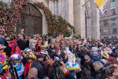 Photo for 2023 New York City Easter Bonnet Parade. April 09, 2023, New York, New York, USA: People wearing costumes and lavishly decorated hats crowding on the steps of St. Patrick's Cathedral during the Easter Parade and Bonnet Festival 2023 - Royalty Free Image