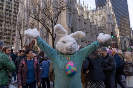 Photo for 2023 New York City Easter Bonnet Parade. April 09, 2023, New York, New York, USA: A man dress as an Easter Bunny attends the Easter Parade and Bonnet Festival 2023 outside St. Patrick's Cathedral along Fifth Avenue - Royalty Free Image