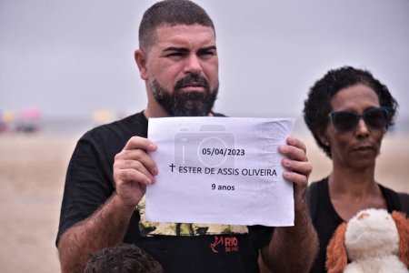 Photo for (INT) NGO promotes a protest against the death of killed Ester Oliveira at Copacabana Beach. April 08, 2023, The NGO Rio de Paz promoted a protest against the death of 9-year-old girl Ester de Assis Oliveira on Copacabana Beach - Royalty Free Image