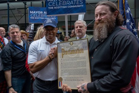 Photo for 25th Annual New York City Tartan Day Parade. April 15, 2023, New York, New York, USA: New York City Mayor Eric Adams present proclamation to Kyle Dawson pose with VIP during the 25th Annual Tartan Day Parade in Manhattan on April 15, 2023 - Royalty Free Image