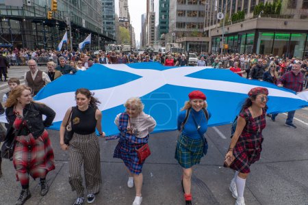 Photo for 25th Annual New York City Tartan Day Parade. April 15, 2023, New York, New York, USA: Participants carrying a large Scottish flag march at the 25th Annual Tartan Day Parade in Manhattan on April 15, 2023 in New York City. - Royalty Free Image