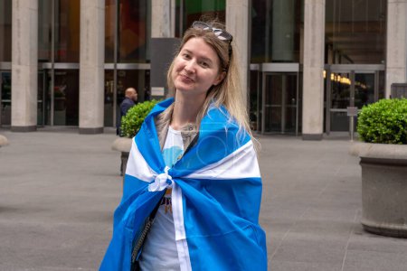 Photo for 25th Annual New York City Tartan Day Parade. April 15, 2023, New York, New York, USA: Spectators holding Scottish flags cheer on participants at the 25th Annual Tartan Day Parade in Manhattan on April 15, 2023 in New York City. - Royalty Free Image