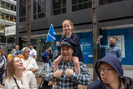 Photo for 25th Annual New York City Tartan Day Parade. April 15, 2023, New York, New York, USA: 5 years old Teigen holding a Scottish flag cheers on participants at the 25th Annual Tartan Day Parade in Manhattan on April 15, 2023 in New York City. - Royalty Free Image