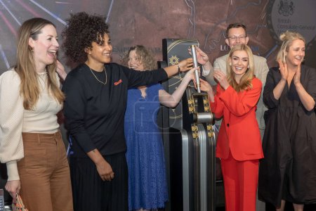 Photo for His Majesty's Consul General of New York Emma Wade-Smith Lights the Empire State Building in Celebration of the Coronation. May 05, 2023, New York, New York, USA: (L-R) Hannah Young, Shantell Martin, His Majesty's Consul General - Royalty Free Image