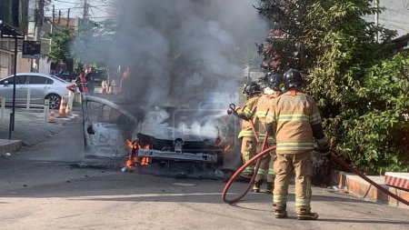 Photo for A passenger car caught fire in Rio de Janeiro. May 09, 2023, Rio de Janeiro, Brazil: A passenger car was completely destroyed by a fire on Tuesday (09) morning on Rua Tenente Palestrina in the neighborhood of Cordovil. - Royalty Free Image