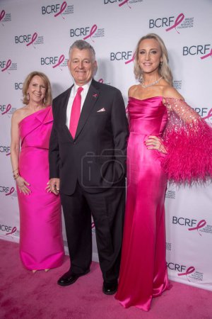 Photo for Breast Cancer Research Foundation Hot Pink Party. May 09, 2023, New York, New York, USA: (L-R) Elizabeth Hurley, William Lauder and Kinga Lampert attend the Breast Cancer Research Foundation Hot Pink Party at The Glasshouse on May 09, 2023 - Royalty Free Image