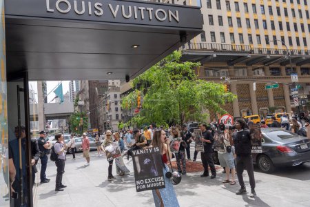 Photo for Anti-Fur Protest. May 13, 2023, New York, New York, USA: Animal Rights protesters holding signs during a protest in front of the Louis Vuitton store on Fifth Avenue during an Anti-Fur Protest on May 13, 2023 in New York City. - Royalty Free Image
