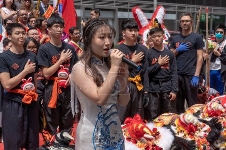 Photo for Second Annual Asian American Pacific Islander (AAPI) Cultural Heritage Parade. May 21, 2023, New York, New York, USA: A participant sing national anthem of the United States at the Second Annual Asian American and Pacific Islander (AAPI) - Royalty Free Image