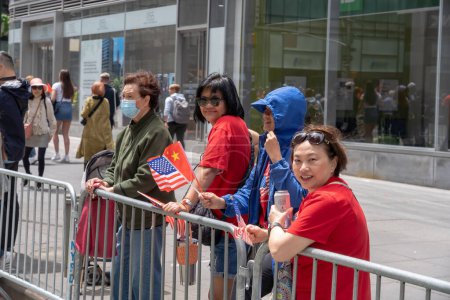 Photo for Second Annual Asian American Pacific Islander (AAPI) Cultural Heritage Parade. May 21, 2023, New York, New York, USA: Spectators with Chinese and American flags watch and cheer during the New York City - Royalty Free Image