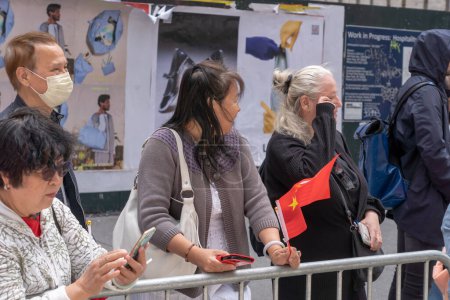 Photo for Second Annual Asian American Pacific Islander (AAPI) Cultural Heritage Parade. May 21, 2023, New York, New York, USA: Spectators with Chinese and American flags watch and cheer during the New York City - Royalty Free Image
