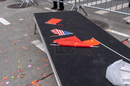 Photo for Second Annual Asian American Pacific Islander (AAPI) Cultural Heritage Parade. May 21, 2023, New York, New York, USA: Abandon Chinese and American flags and confetti litter Sixth Avenue during the New York City - Royalty Free Image
