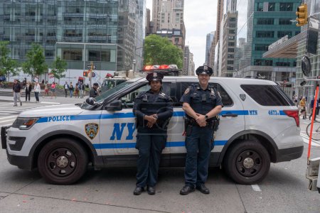 Photo for Second Annual Asian American Pacific Islander (AAPI) Cultural Heritage Parade. May 21, 2023, New York, New York, USA: New York Police Department (NYPD) Officers from Manhattan North 18 Precinct stand watch during the New York City - Royalty Free Image