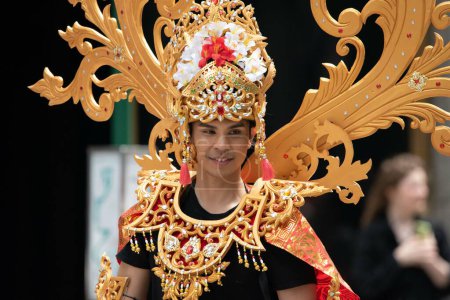 Photo for Indonesian man with  with gold crown and gold attire at the second annual AAPI Parade on Sixth Avenue (Avenue of the Americas). May 21, 2023. New York, USA The Asian American and Pacific Islander (AAPI) Cultural and Heritage Parade - Royalty Free Image