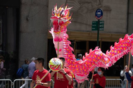Photo for Pink, red, and Yellow Dragon at the second annual AAPI Parade on Sixth Avenue (Avenue of the Americas). May 21, 2023. New York, USA The Asian American and Pacific Islander (AAPI) Cultural and Heritage Parade - Royalty Free Image