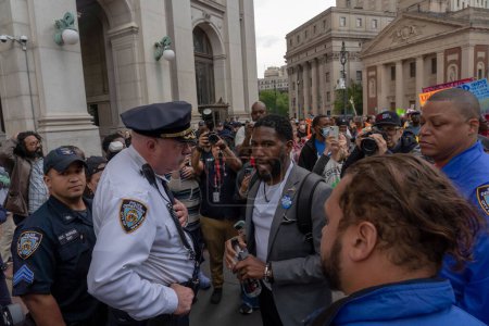 Photo for Two Arrested At A Rally and March to Protest Mayor Adam's Budget Cuts. May 24, 2023, New York, New York, USA: Public Advocate Jumaane Williams (R) talks with Chief McCarthy, Commanding Officer of Patrol Borough Manhattan South - Royalty Free Image