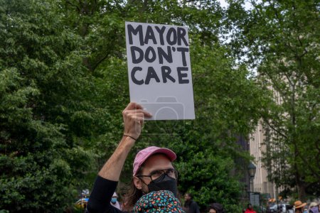 Photo for (NEW) Two Arrested At A Rally and March to Protest Mayor Adam&#39;s Budget Cuts. May 24, 2023, New York, New York, USA: Protester holds a &quot;MAYOR DON&#39;T CARE&quot; sign at a rally and a march to protest Mayor Eric Adam&#39;s budget cuts at Fol - Royalty Free Image
