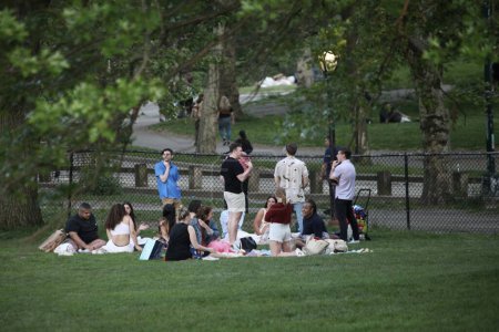 Photo for Memorial Day Weekend 2023 Celebrated on Central Park Lawn. May 27, 2023, New York, USA: New Yorkers and loved ones are seen celebrating Memorial Day Weekend on New York City Central Park Lawn with picnic, food, music, love, games - Royalty Free Image