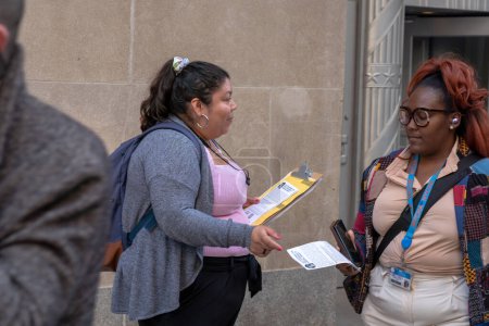 Photo for Protest To Stop The Con Ed Rate Hikes!. May 31, 2023, New York, New York, USA: Carol, Kei , Edmond speak while other activists hand out leaflets to pedestrians during a protest to stop Con Ed rate hikes organized by NYC Party for Socialism - Royalty Free Image