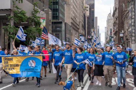 Photo for The 2023 Celebrate Israel Parade. June 04, 2023, New York, New York, USA: Participants holding Israeli flags and signs march up Fifth Avenue during the Celebrate Israel Parade on June 4, 2023 in New York City. - Royalty Free Image