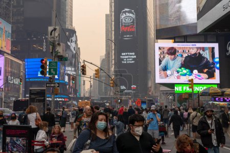 Foto de Smoke From Canadian Wildfires Blows South Creating Hazy Conditions On Large Swath Of Eastern U.S.. 07 de junio de 2023, Nueva York, Nueva York, Estados Unidos: Los peatones con máscaras recorren Times Square en medio del humo de los incendios forestales canadienses - Imagen libre de derechos