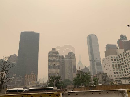 Photo for Smoked Filled Air of New York City. June 7, 2023, New York, USA: The entire air of New York City has been polluted with smoke coming from Canada causing New Yorkers and tourists to mask up to prevent being contaminated. The air quality in New York - Royalty Free Image