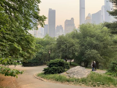 Photo for Central Park-NYC Under  Wildfire Smoke from Canada. June 7, 2023, New York, USA: A cloud of smoke reaches the US from Canada, where hundreds of wildfires affect the country. The US has issued warnings for vulnerable populations to stay indoors. - Royalty Free Image