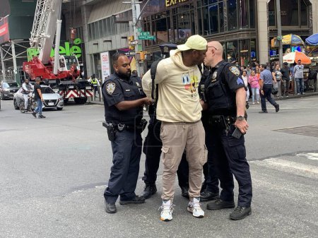 Photo for NYPD arrests illegal dealers at Time Square. June 15, 2023, New York, USA: NYPD is at full force to clean any illegal deals going on at Times Square as they arrest two suspects and whisked them to a nearby Police station - Royalty Free Image