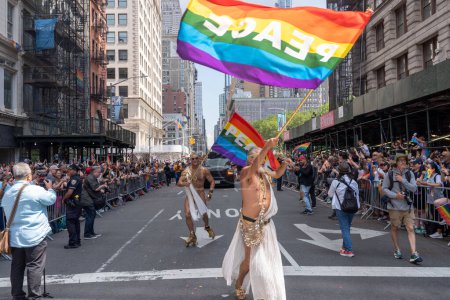 Photo for 2023 New York City Pride March. June 25, 2023, New York, New York, USA: Men wave rainbow flags as they participate in the annual New York City Pride Parade on June 25, 2023 in New York City. - Royalty Free Image