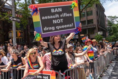 Photo for 2023 New York City Pride March. June 25, 2023, New York, New York, USA: A spectator holds a &quot;Ban Assault Rifles NOT Drag Queens!&quot; sign during the annual New York City Pride Parade on June 25, 2023 in New York City. - Royalty Free Image