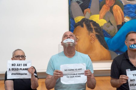 Photo for (NEW) Climate Activists Hold a Protest in New York#39;s Metropolitan Museum of Art. July 08, 2023, New York, USA: Members of Extinction Rebellion NYC and Rise and Resist with strips of tape on the mouth - Royalty Free Image
