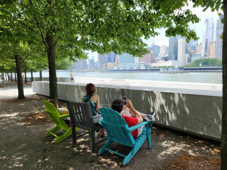 Photo for Summer Saturday on Roosevelt Island in New York . July 15, 2023. Roosevelt Island, New York, USA: With high temperatures and heavy traffic on Roosevelt Island, New York, NY, on the banks of the Est River, the population and tourists - Royalty Free Image