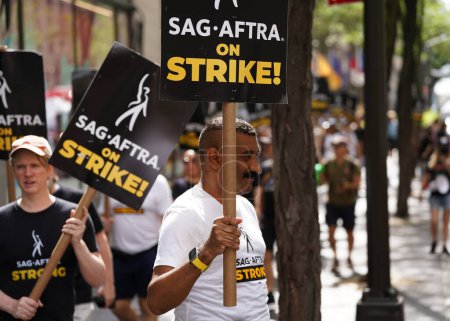 Photo for SAG-AFTRA on Strike at NBC Universal in Rockefeller Plaza.July 21, 2023, New York USA : "SAG-AFTRA members stage powerful strike at NBC Universal in Rockefeller Plaza, demanding fair wages, better working conditions - Royalty Free Image