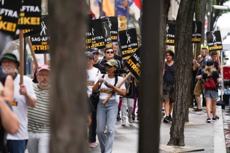 Photo for SAG-AFTRA on Strike at NBC Universal in Rockefeller Plaza.July 21, 2023, New York USA : "SAG-AFTRA members stage powerful strike at NBC Universal in Rockefeller Plaza, demanding fair wages, better working conditions - Royalty Free Image