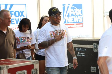 Photo for Flo Rida performs live at Fox and Friends. July 28, 2023, New York, USA: American Rapper Flo Rida performs live at Fox and Friends to the delight of fans who danced and sang along his music. Some of the fans waited to get his autograph - Royalty Free Image