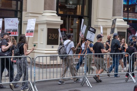 Photo for Writers Guild of America picket. August 15, 2023, New York, New York, USA: Striking members of Writers Guild of America and supporters walk on a picket line outside Netflix and Warner Bros./ Discovery office on August 15, 2023 in New York City. - Royalty Free Image