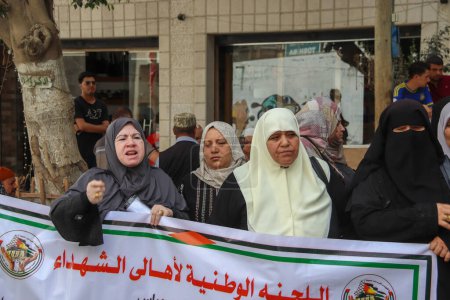 Photo for Palestinian Families Protest Against The Authority to cut Salaries. September 12, 2023, Gaza, Palestine: Palestinian families of the martyrs and the wounded, take part in a protest against the Palestinian Authority's decision - Royalty Free Image