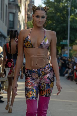 Photo for September 16, 2023 - New York, USA: A model walks the runway at the Edwing; Angelo fashion show on a Harlem Street during New York Fashion Week September 2023. - Royalty Free Image