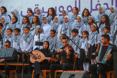Photo for (NEW) Palestinians participate in a musical celebration. September 17, 2023, Gaza , Palestine: Palestinians participate in a musical celebration in which a choir team participates in the youth leadership project implemented by the Save the Future You - Royalty Free Image