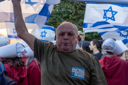 Téléchargez les photos : Des expatriés israéliens et des juifs américains manifestent lors de la visite du Premier ministre Netanyahu & # 39 ; s U.N. 19 septembre 2023, New York, New York, USA : Un expatrié israélien porte la chemise Brothers and Sisters in Arms et tient un drapeau israélien lors d'un rassemblement - en image libre de droit