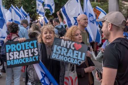 Photo for Israeli Expats and US Jews Protest During Prime Minister Netanyahu U.N. Visit. September 19, 2023, New York, New York, USA: Protester holds a protect Israel Democracy and NYC  Israeli Democracyat - Royalty Free Image