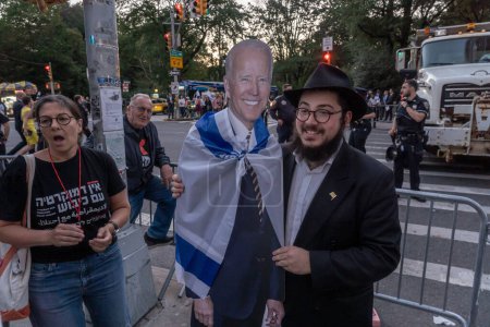 Photo for Israeli Expats and US Jews Protest During Prime Minister Netanyahu's U.N. Visit. September 19, 2023, New York, New York, USA: An orthodox Jew in favor the judicial overhaul poses with President Biden cardboard cutout draped in Israeli flag - Royalty Free Image