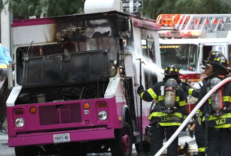 Photo for Ice Cream Van on fire. September 21, 2023, New York, USA: An Ice cream van stationed beside Radio City Music Hall on 50th street with 6th Avenue was on fire and with a total damage. - Royalty Free Image