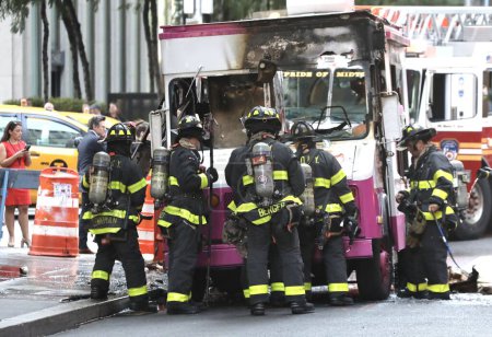 Photo for Ice Cream Van on fire. September 21, 2023, New York, USA: An Ice cream van stationed beside Radio City Music Hall on 50th street with 6th Avenue was on fire and with a total damage. - Royalty Free Image