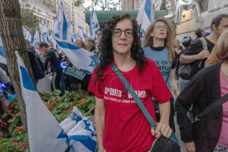 Photo for Israeli Expats and US Jews Protest During Prime Minister Netanyahu's U.N. Visit. September 21, 2023, New York, New York, USA: A woman wears a Protest of Women (in Hebrew) shirt at an opposition of the judicial overhaul protest - Royalty Free Image