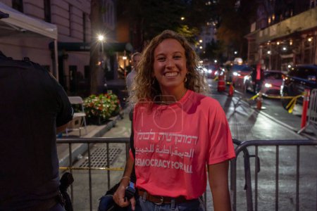Photo for Israeli Expats and US Jews Protest During Prime Minister Netanyahu's U.N. Visit. September 21, 2023, New York, New York, USA: A woman wears a Democracy For All  shirt at an opposition of the judicial overhaul protest - Royalty Free Image