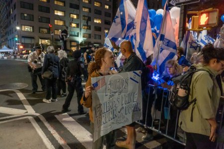 Photo for Israeli Expats and US Jews Protest During Prime Minister Netanyahu's U.N. Visit. September 21, 2023, New York, New York, USA: A protester holds a Friends Don't Let Friends Drive Drunk with Power - Royalty Free Image