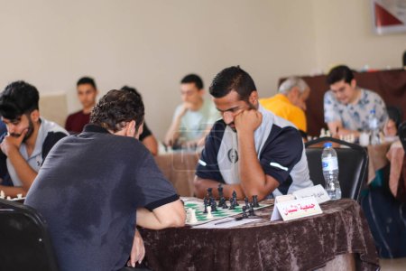 Photo for (SPO) Palestinians compete during a local chess tournament in Gaza. September 24, 2023. Gaza, Palestine: Palestinians compete during a local chess tournament in Gaza City. - Royalty Free Image