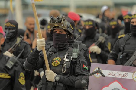 Photo for October 4, 2023 - Gaza, Palestine: Fighters from the Al-Quds Brigades, the military wing of the Islamic Jihad Movement in Palestine, participate  in a military parade on the 36th movement, in Gaza Strip. - Royalty Free Image