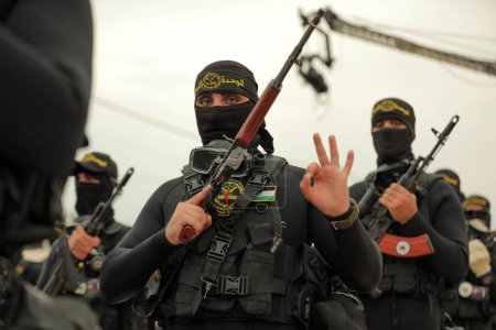 Photo for October 4, 2023 - Gaza, Palestine: Fighters from the Al-Quds Brigades, the military wing of the Islamic Jihad Movement in Palestine, participate  in a military parade on the 36th movement, in Gaza Strip. - Royalty Free Image